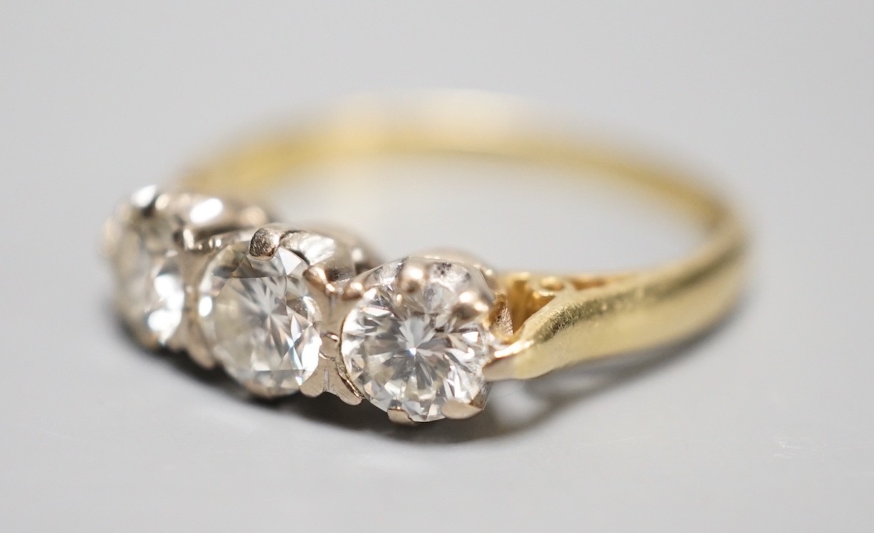 A modern 18ct gold and three stone diamond ring, size L, gross weight 3.3 grams